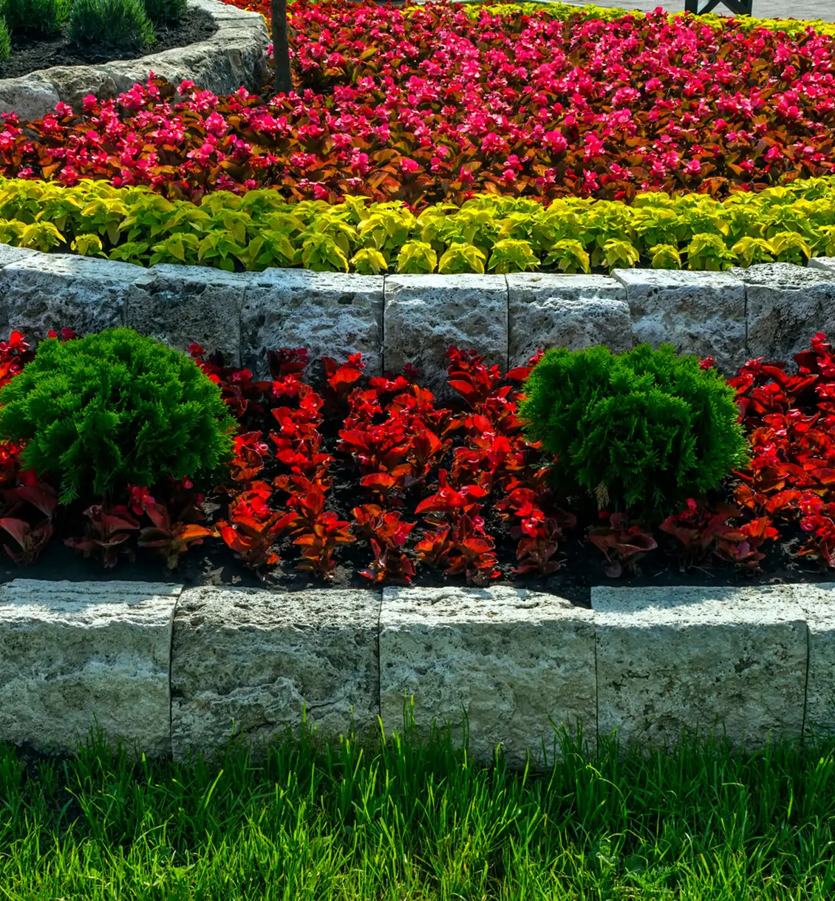 Colorful tiered flower garden with stone borders