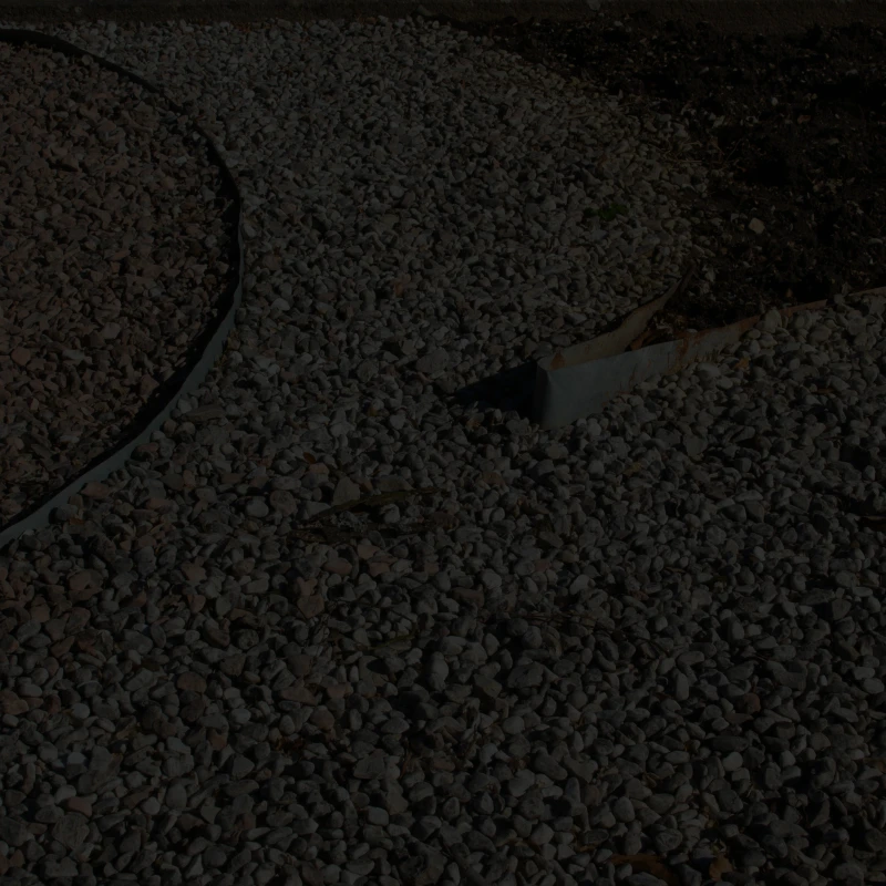 Pebble-covered ground with metal edging